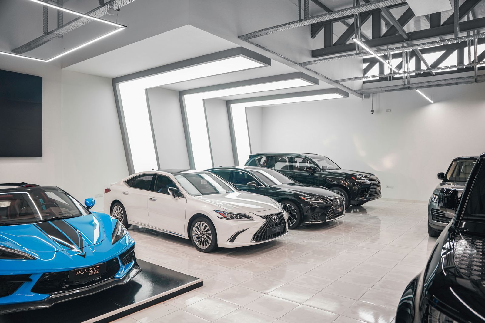 Luxury cars lined up in a bright modern showroom